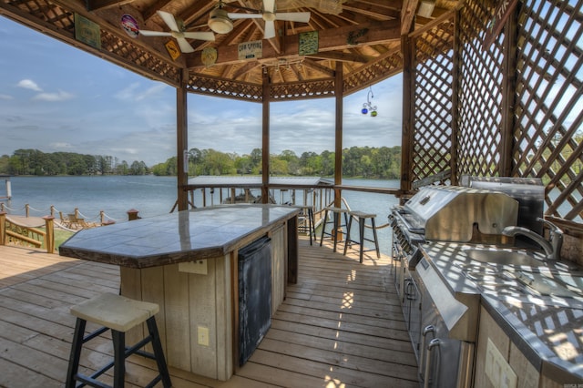 view of dock featuring a bar and a deck with water view