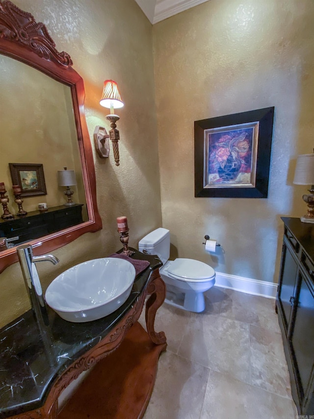 bathroom featuring tile flooring, toilet, and vanity