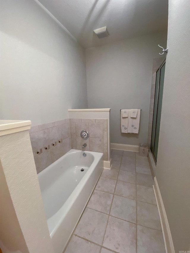 bathroom featuring tile flooring and separate shower and tub