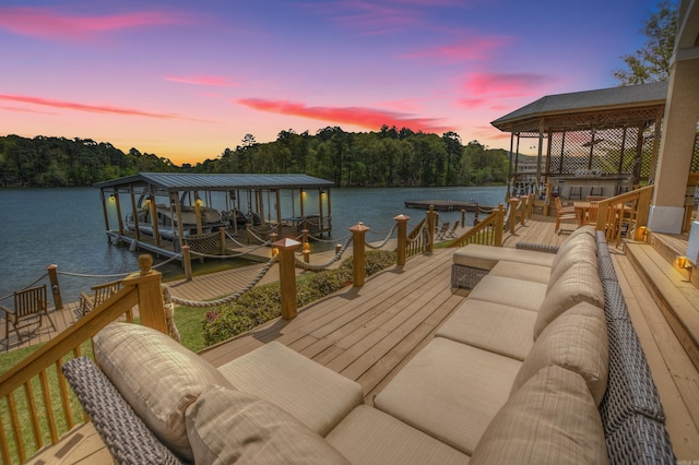 view of dock with a deck with water view and outdoor lounge area