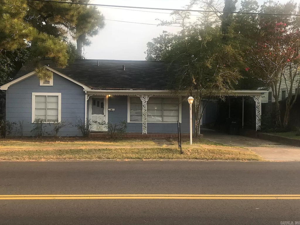 single story home featuring a carport