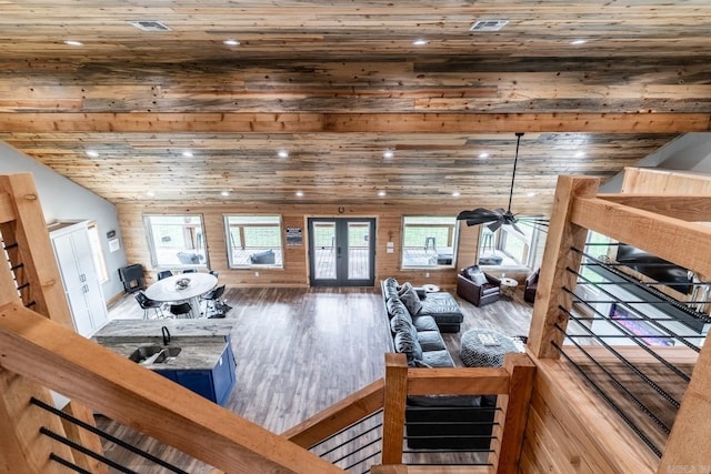 living room featuring dark hardwood / wood-style flooring, french doors, lofted ceiling, and ceiling fan