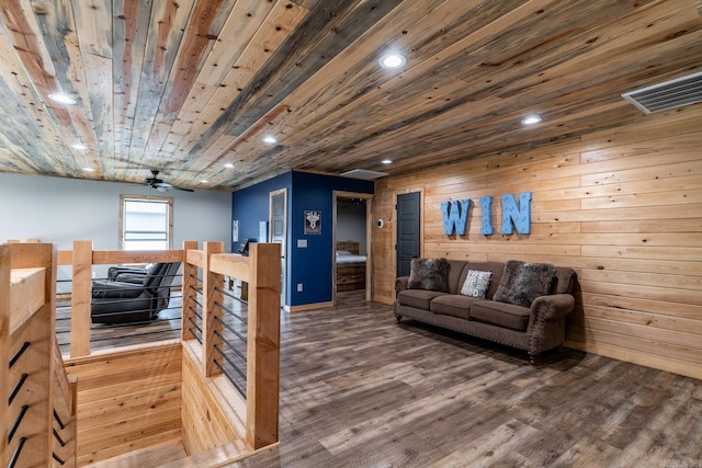 living room with dark hardwood / wood-style flooring, ceiling fan, and wood ceiling