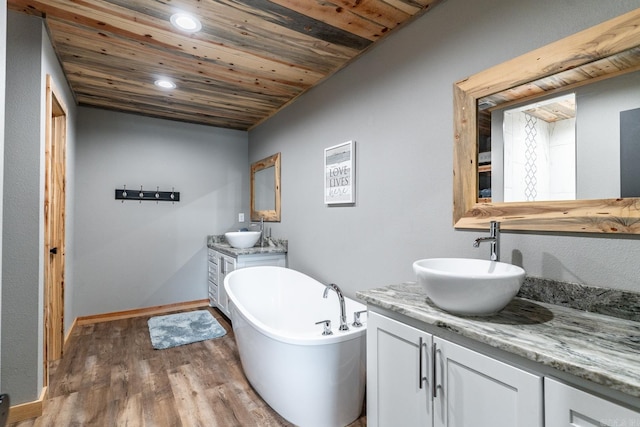 bathroom featuring wooden ceiling, a bathtub, vanity, and hardwood / wood-style floors