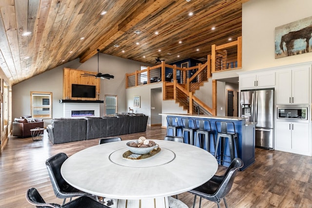 dining room with ceiling fan, high vaulted ceiling, dark hardwood / wood-style floors, and wooden ceiling