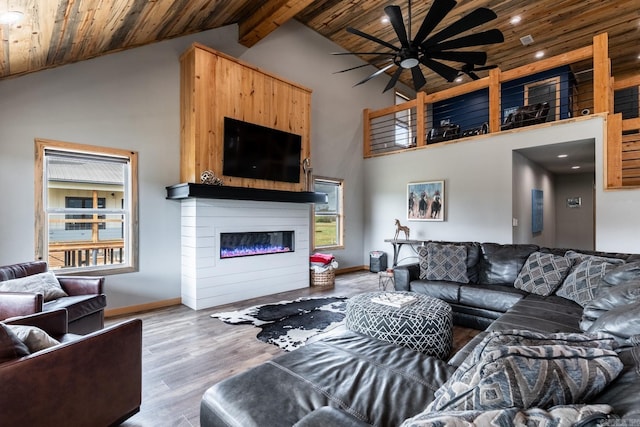 living room featuring beamed ceiling, ceiling fan, high vaulted ceiling, hardwood / wood-style flooring, and wooden ceiling