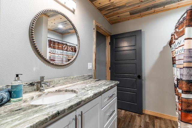 bathroom with oversized vanity, wood ceiling, and wood-type flooring