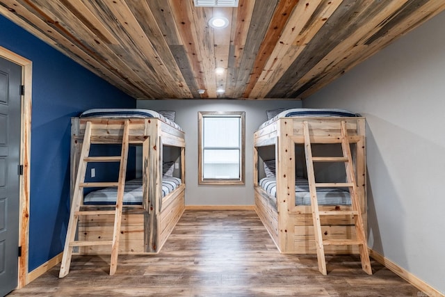 unfurnished bedroom featuring dark hardwood / wood-style flooring and wood ceiling