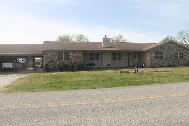 ranch-style house featuring a carport and a front lawn