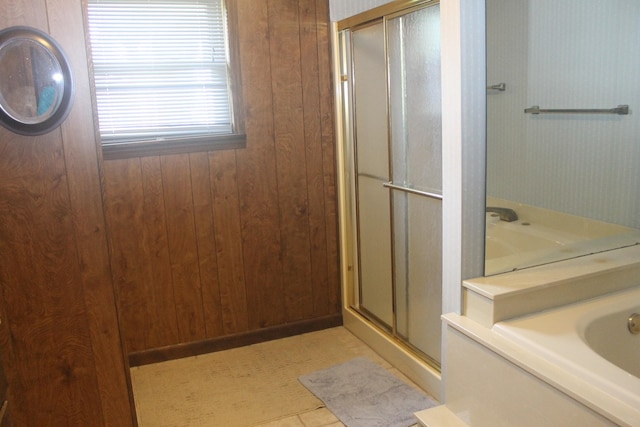 bathroom featuring plus walk in shower, tile patterned floors, and wooden walls