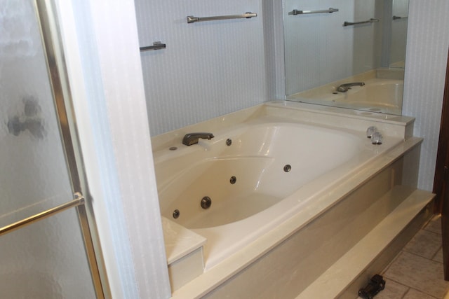 bathroom with a bathtub and tile patterned floors