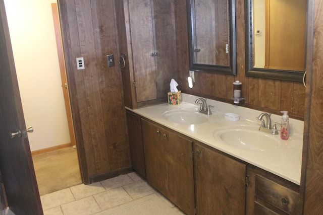 bathroom with vanity, wooden walls, and tile patterned flooring