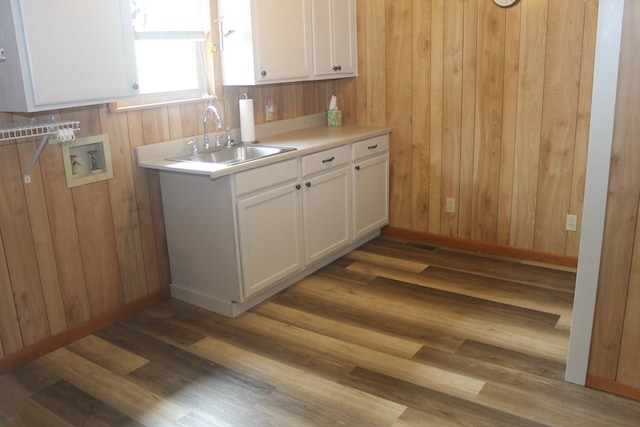 kitchen with white cabinetry, sink, and dark wood-type flooring