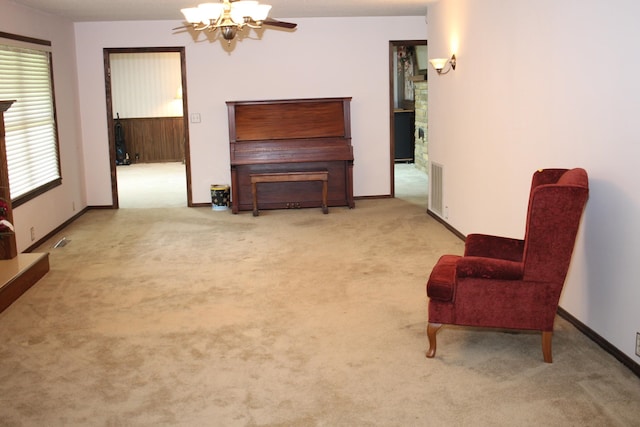 living area with light colored carpet and a chandelier