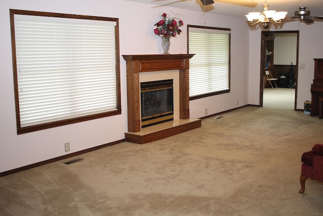 unfurnished living room with carpet floors and ceiling fan with notable chandelier