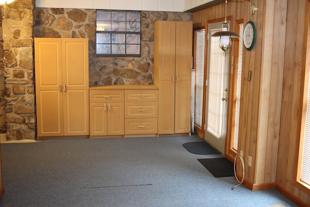 doorway to outside with a healthy amount of sunlight and carpet floors