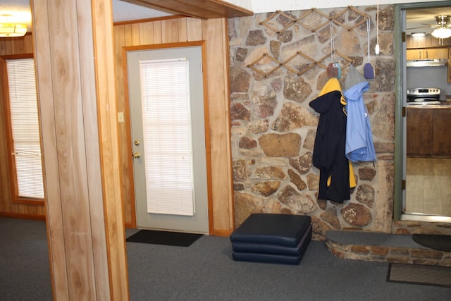 interior space with carpet floors and wood walls