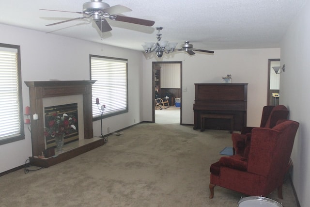 living room with ceiling fan with notable chandelier and carpet