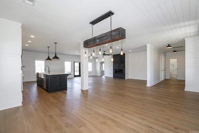 unfurnished living room with dark hardwood / wood-style flooring and sink