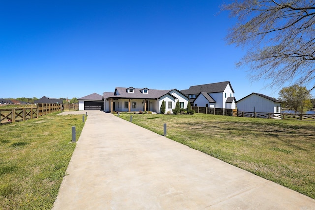 view of front facade featuring a front yard and a garage