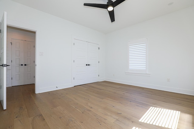 empty room with ceiling fan and light wood-type flooring