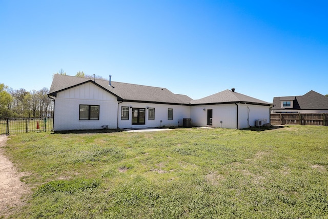 back of house featuring a patio area and a yard