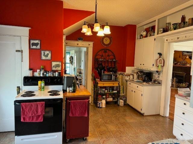 kitchen featuring hanging light fixtures, electric range, white cabinets, a notable chandelier, and light tile floors