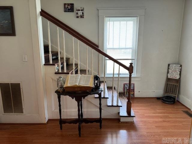 stairs featuring light hardwood / wood-style flooring