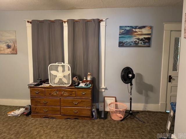 carpeted bedroom featuring a textured ceiling