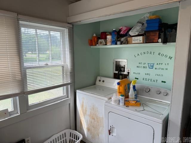 clothes washing area with plenty of natural light, hookup for a washing machine, and washing machine and clothes dryer