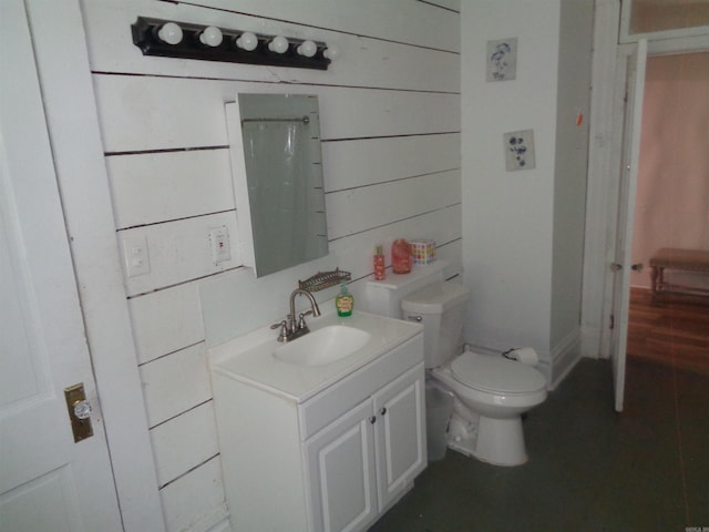 bathroom featuring toilet and vanity