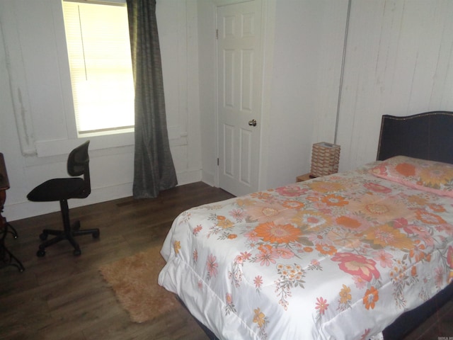 bedroom with dark wood finished floors