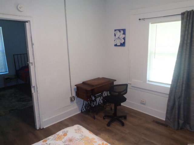 office space featuring baseboards, visible vents, and dark wood-style flooring