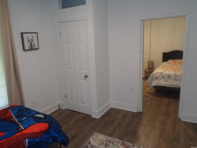 bedroom featuring baseboards and dark wood finished floors