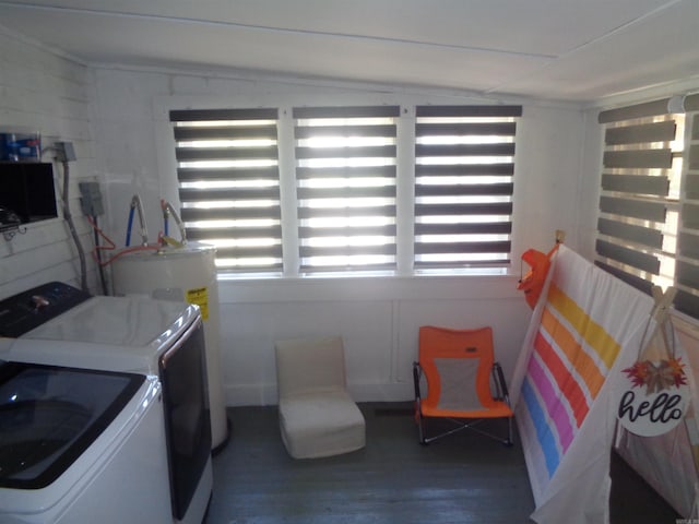 laundry area featuring laundry area, electric water heater, wood finished floors, and independent washer and dryer