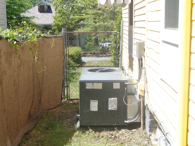 exterior details with fence and central air condition unit