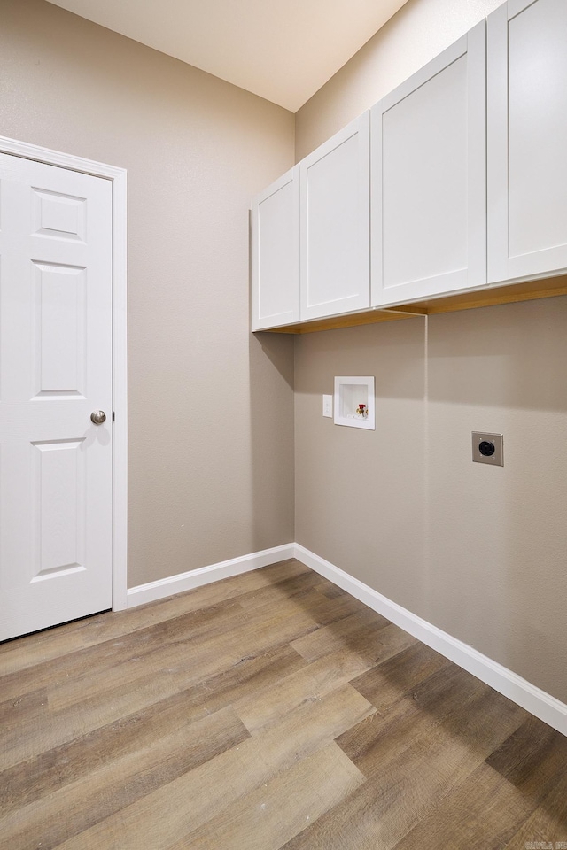 clothes washing area with light wood-type flooring, washer hookup, cabinets, and electric dryer hookup