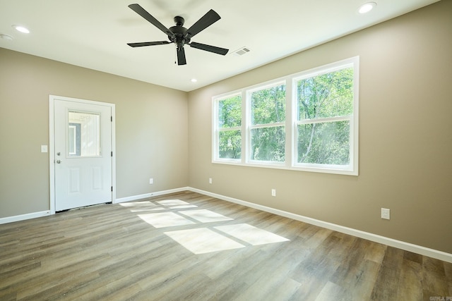 unfurnished room with light hardwood / wood-style flooring and ceiling fan