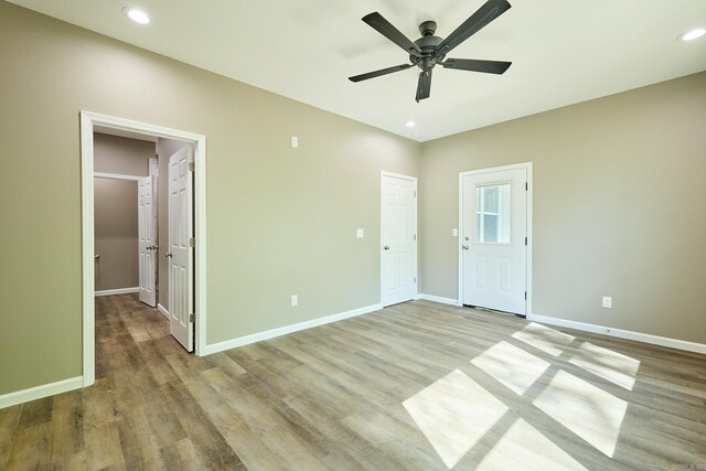 empty room featuring light wood-type flooring and ceiling fan