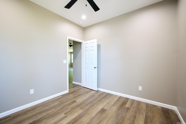 empty room featuring light wood-type flooring and ceiling fan