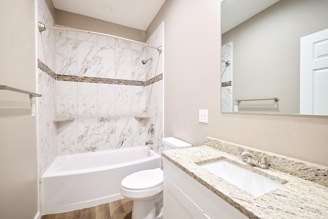 full bathroom featuring vanity, toilet, tiled shower / bath combo, and hardwood / wood-style floors