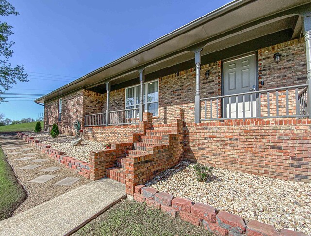 doorway to property featuring covered porch