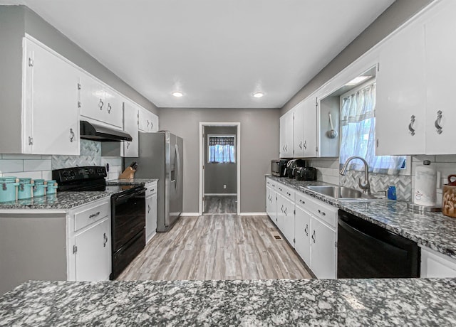 kitchen featuring backsplash, white cabinets, black appliances, and sink