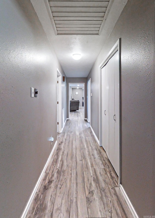 corridor featuring light hardwood / wood-style floors