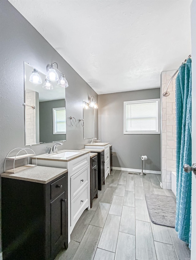 bathroom with tiled shower / bath combo, tile flooring, and dual vanity