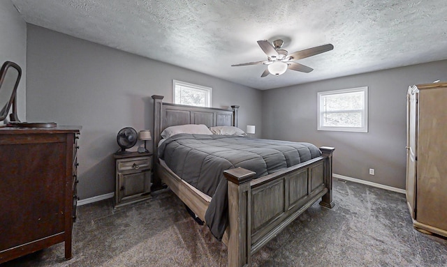 carpeted bedroom featuring ceiling fan and a textured ceiling