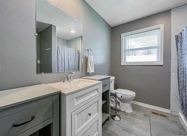 bathroom with large vanity, tile floors, and toilet