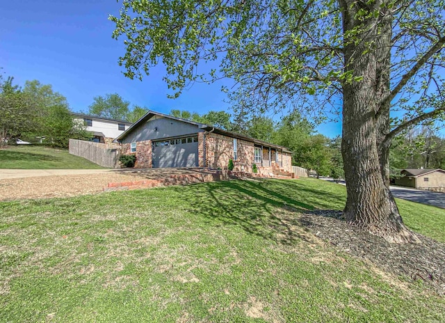 view of front of house with a front yard and a garage