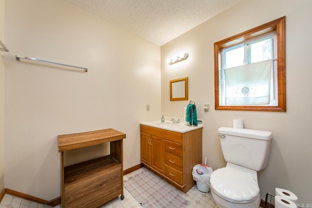 bathroom featuring tile patterned floors, a textured ceiling, vanity, and toilet