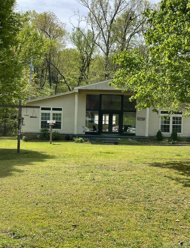 back of property featuring a lawn